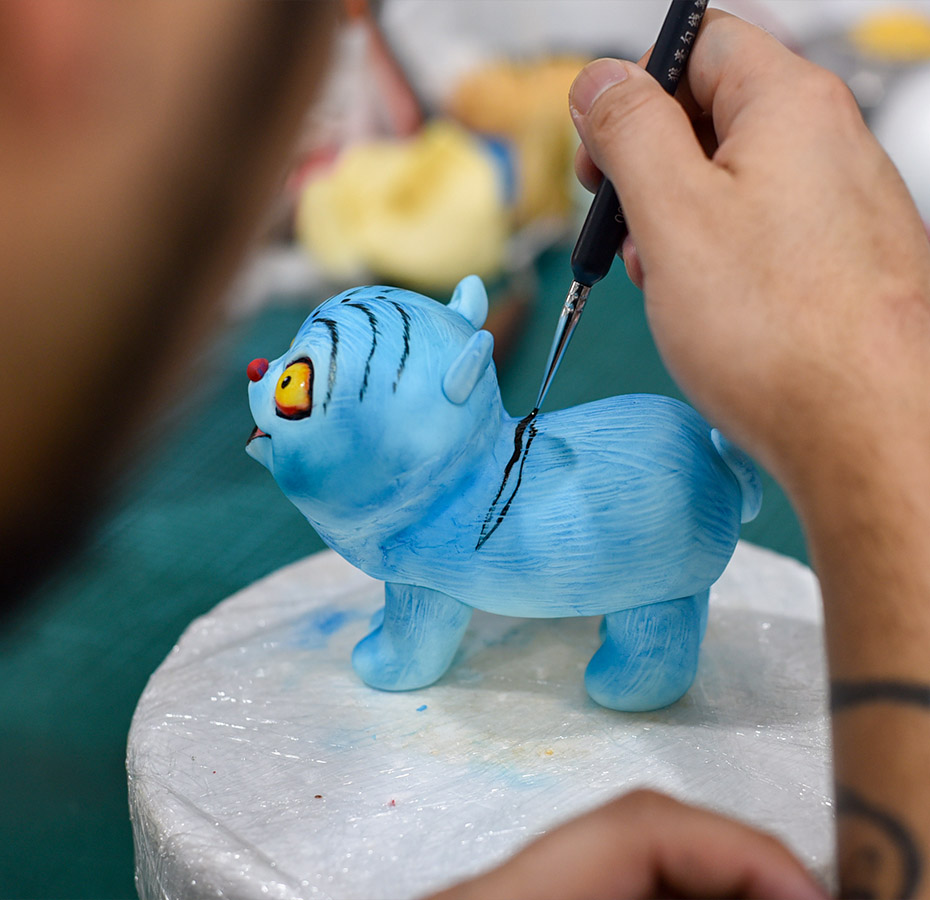 Fondant cake artist decorating fondant cake topper figure