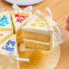Slice of Multi Birthdate Cake lifted out, showing the sponge layers
